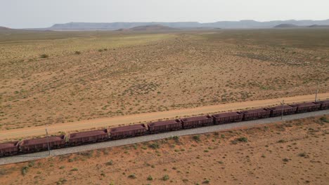 aerial tracking shot of ore wagons on sishen to saldanha railway line, south africa