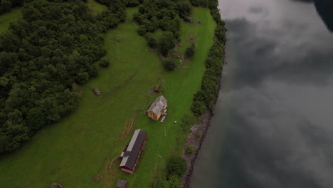 DNT-hoesmbu-home-in-eikesdalsvatnet-fjord,-Norway,-Lake-establishment-aerial