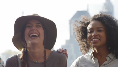 friends visiting new york with manhattan skyline in background