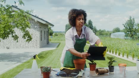 woman gardening with a tablet