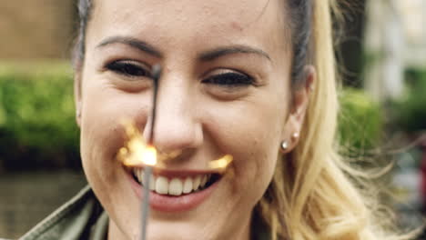 woman holding sparkler celebrating independence day