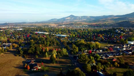 us, oregon, phoenix - drone flight over residential areas towards roxy ann peak in the fall