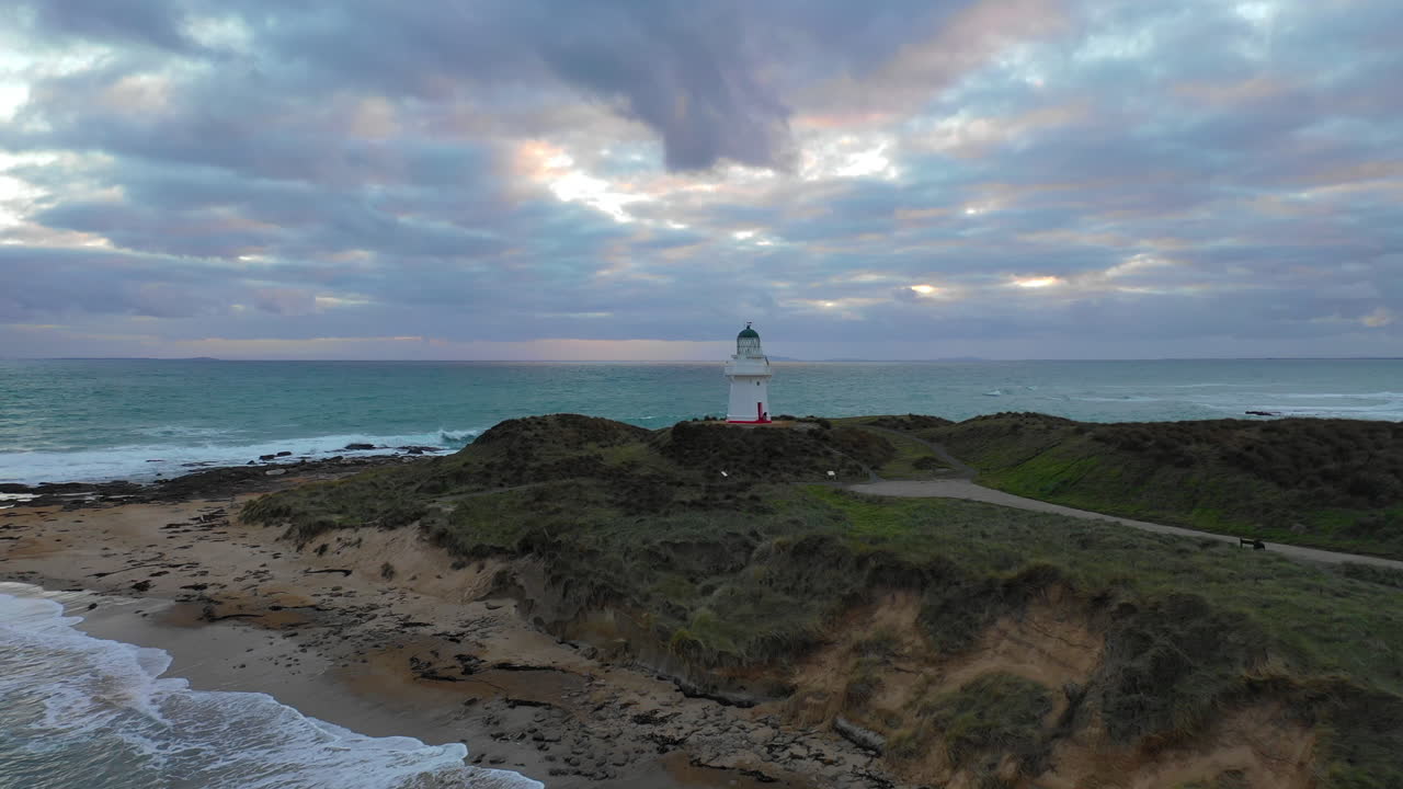 Scenic sunset aerial view of Waipapa Lighthouse on New Zealand's South Island