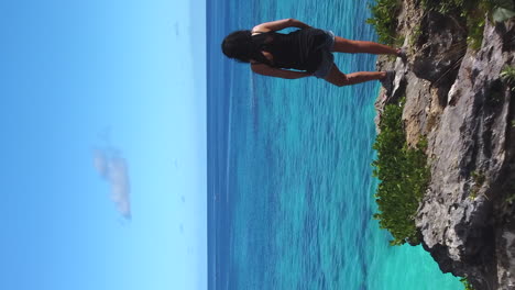 woman admiring view of pacific ocean from maré island bluff