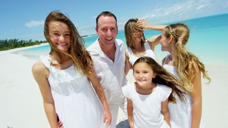 portrait of young caucasian family enjoying beach vacation