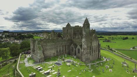 aerial drone shot of castle and grassy landscapes in ireland