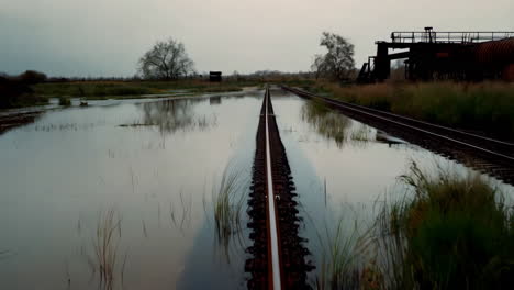 flooded railroad tracks at sunset