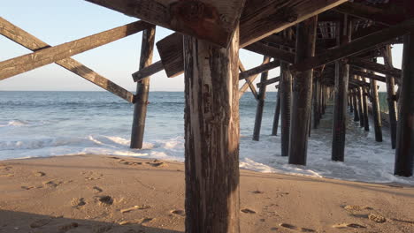 panning shot under pier in seal beach, california