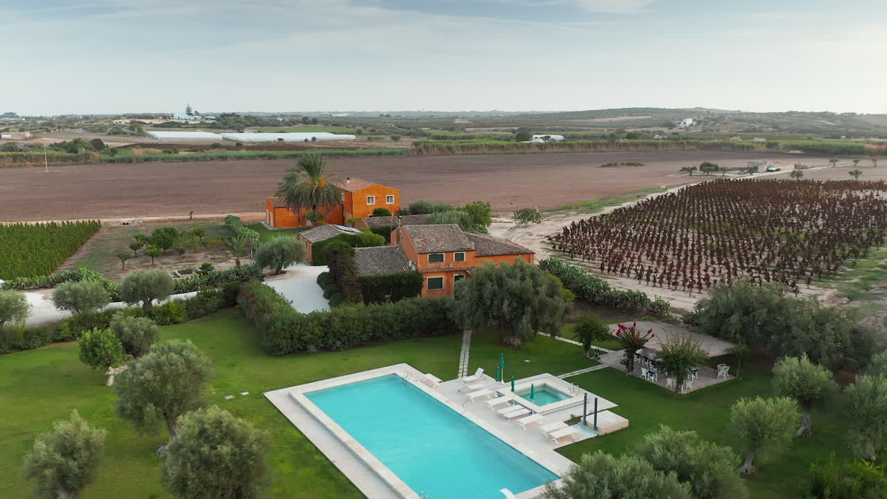 Aerial View Of Outdoor Swimming Pool And Vineyard At Feudo Maccari Winery In Noto, Island Of Sicily In Italy