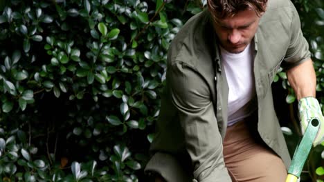 Handsome-man-gardening-with-fork-in-garden