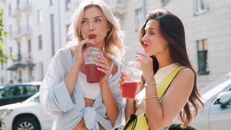 two women enjoying drinks on the street