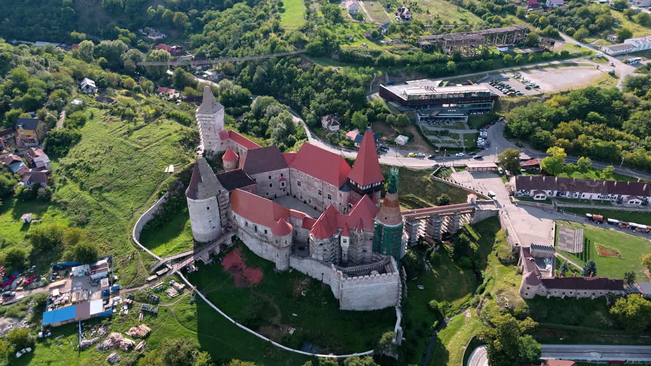 Aerial view of Corvin Castle, Hunedoara, surrounded by lush green landscape