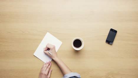 Top-view-woman-spilling-coffee-over-mobile-phone-hands-working-at-desk-from-above---Red-Epic-Dragon