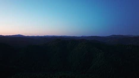 Nächtliche-Drohnenaufnahme-Der-Berg--Und-Waldsilhouette