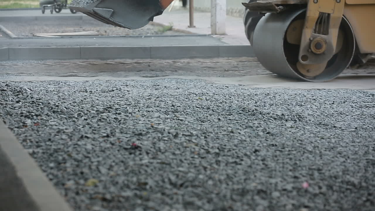 Road roller working on the new road construction site