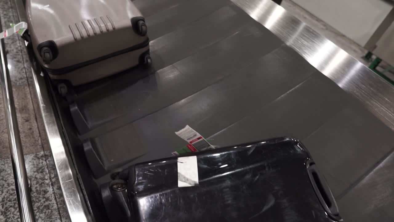 Various luggage baggage with tags moving circle on a luggage carousel for passengers arriving in Europe for holiday