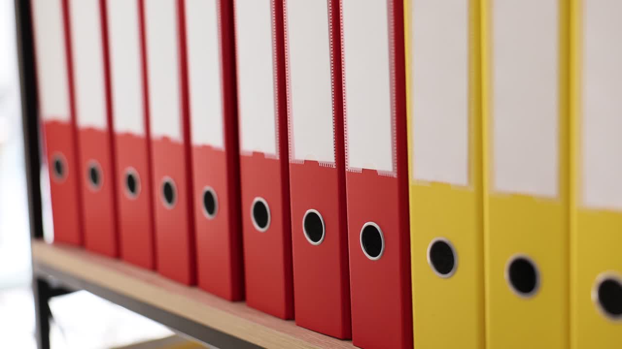Organizing and Storing Colorful Binders on a Shelf