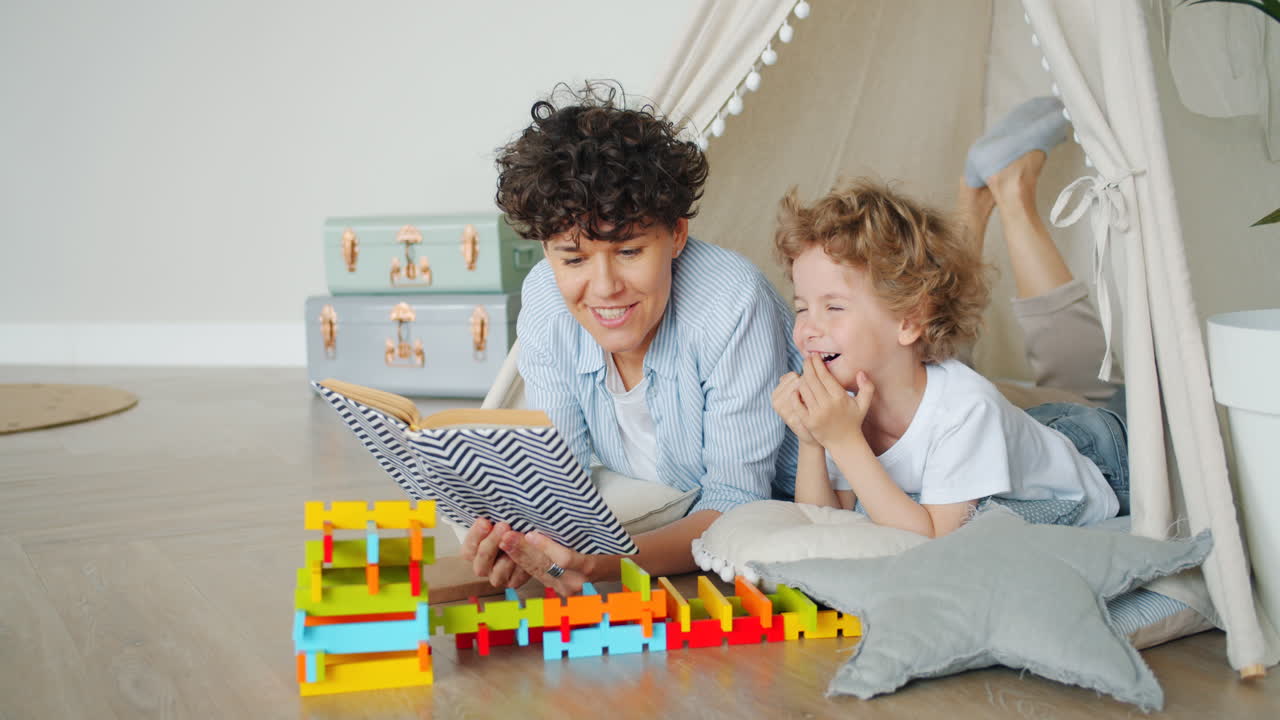 Mother and Son Reading a Book in a Play Tent