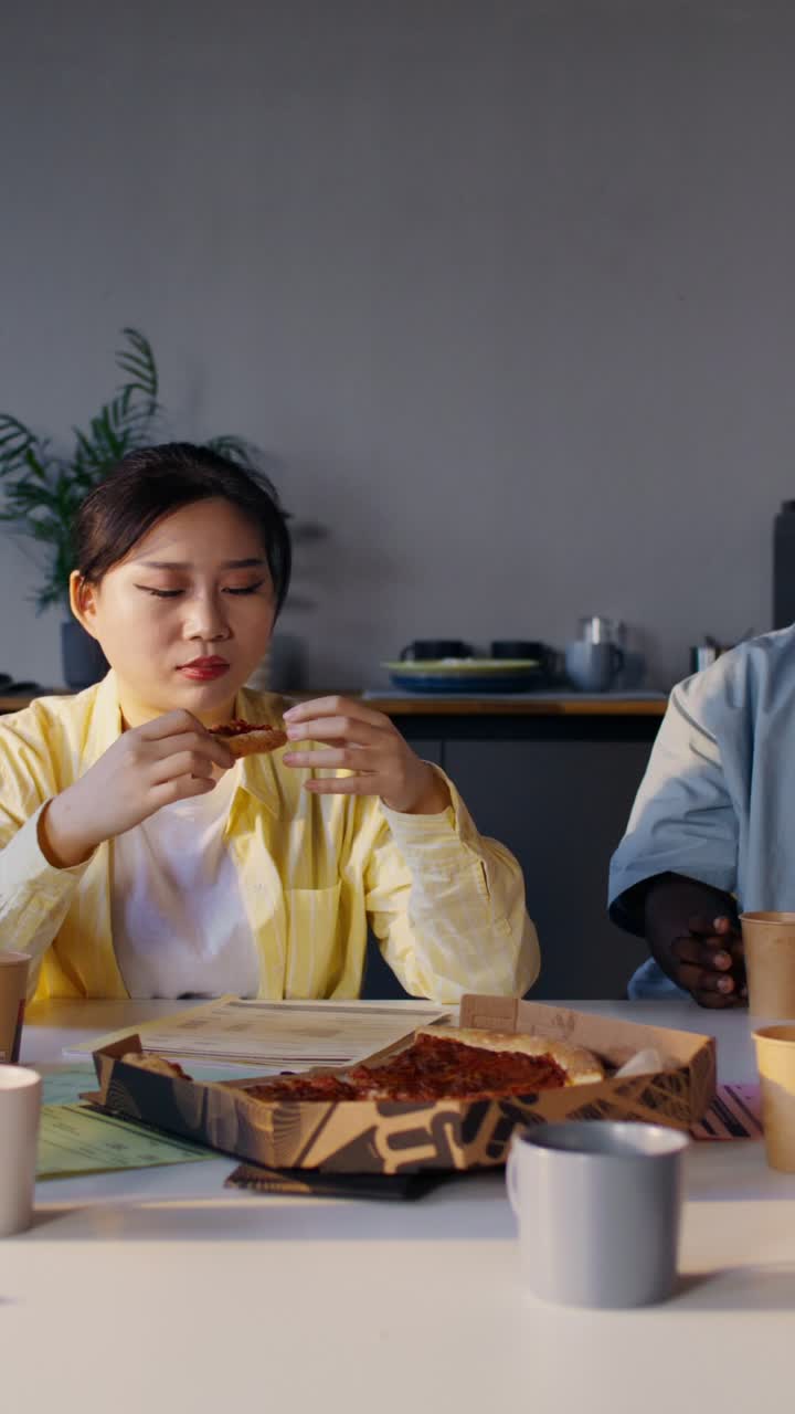 Colleagues Enjoying Pizza Lunch in Office