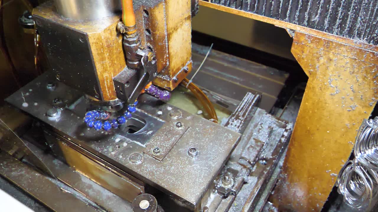 Close-up view of a CNC milling machine in operation, cutting metal parts