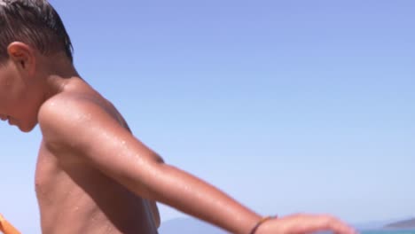 Caucasian-six-years-old-boy,-running-at-beach-of-Stoupa,-Peloponnese,-Greece,-on-a-summer-day-of-2020,-slow-motion