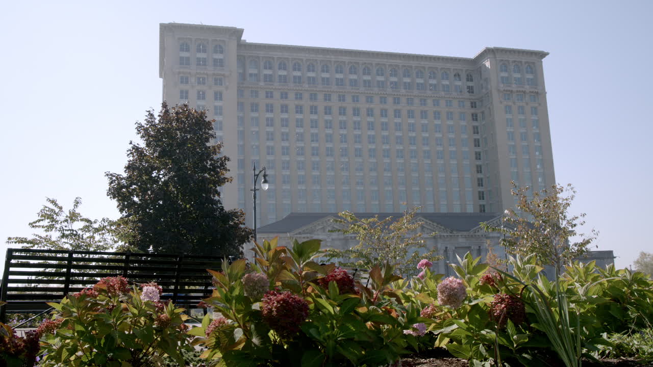 Michigan Central Station with flowers in the foreground in Detroit, Michigan with stable video.