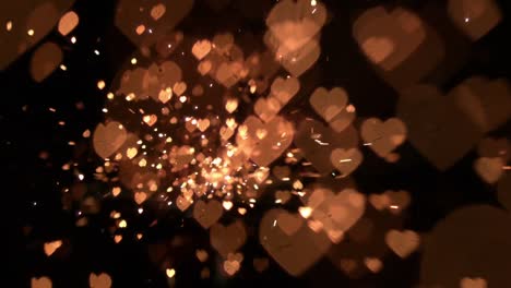 Animation-of-red-kaleidoscope-shapes-with-gold-hearts-and-glitter-falling-on-black-background