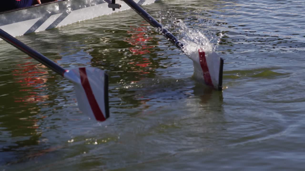 Four senior caucasian men and women rowing boat on a river