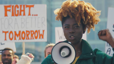 Group-Of-Protestors-With-Placards-And-Megaphone-On-Demonstration-March-For-Gender-Equality