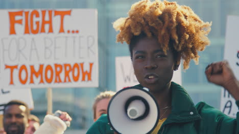 group of protestors with placards and megaphone on demonstration march for gender equality