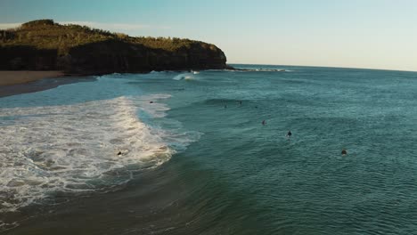 sunset aerial ocean view of the surfers, waves, beach and headland in warriewood, northern beaches, nsw, sydney, australia