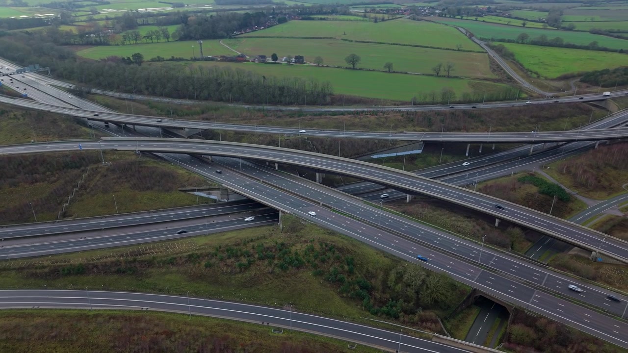 Drone view of the M1 and M6 motorway interchange with complex flyover bridges.