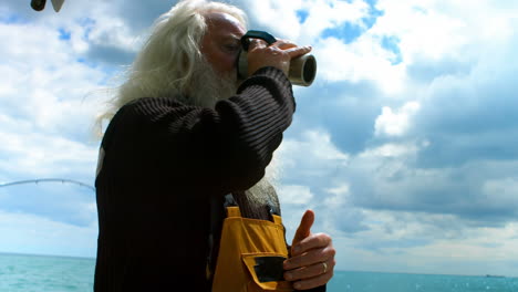 fisherman drinking cup of coffee