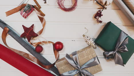 Top-view.-Wooden-brown-table-decorated-with-Christmas-stuff-and-garlands.-Red-Christmas-lights.-Close-up.