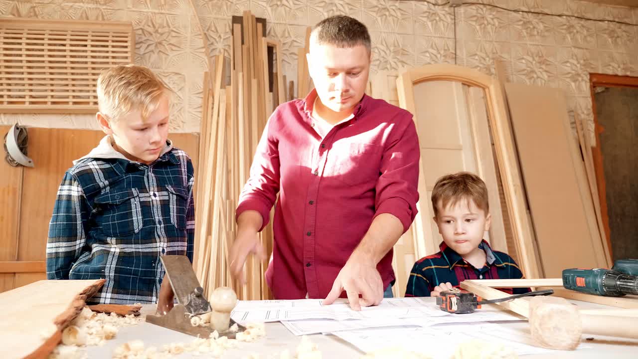 Father and sons learning woodworking in a workshop