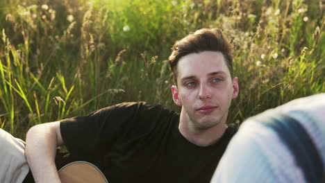 man playing ukelele