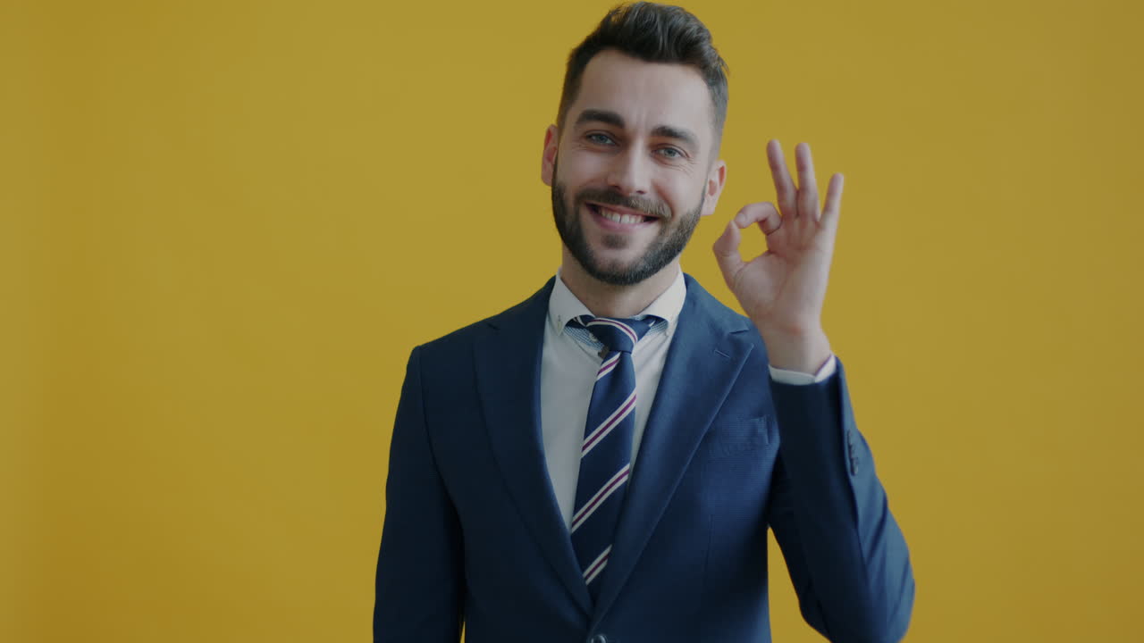 Business man smiling and making ok gesture
