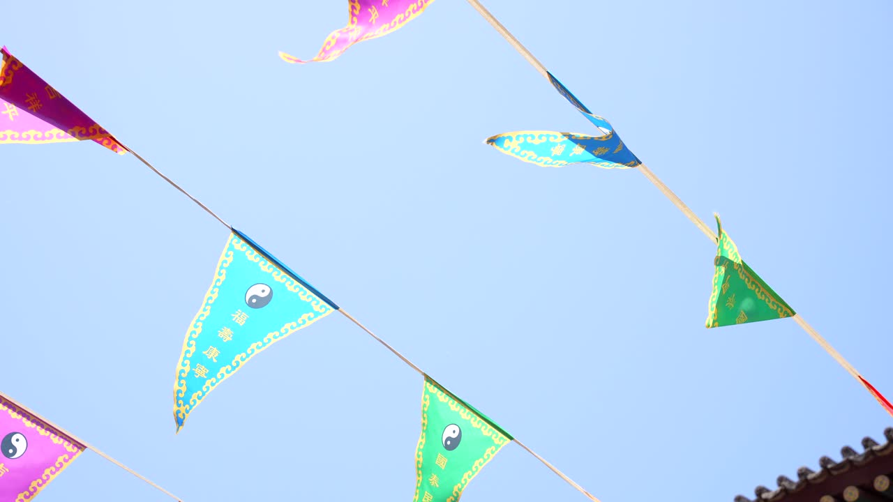 Yin Yang Chinese flags waving against the blue sky in City God Temple of Xian, China