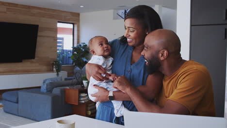 African-American-Family-With-Baby-Daughter-Using-Laptop-To-Check-Finances-At-Home