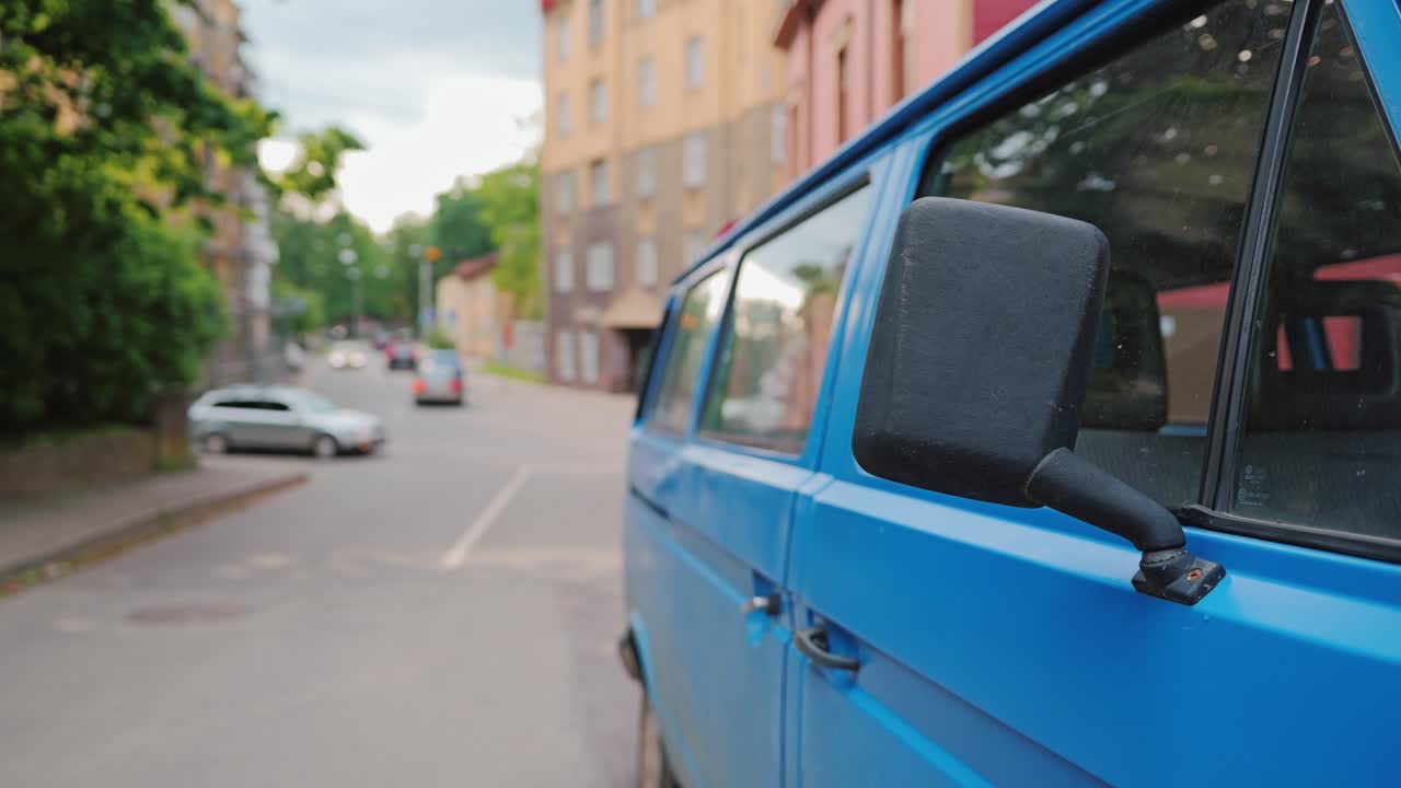 Slow motion urban still of blue van and empty street in Riga during summer haze