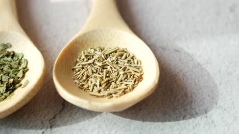 dried herbs in wooden spoons