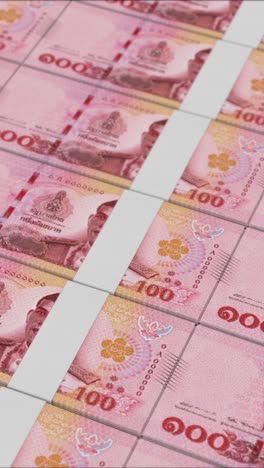 vertical video of 100 thai baht banknotes printed by a money press