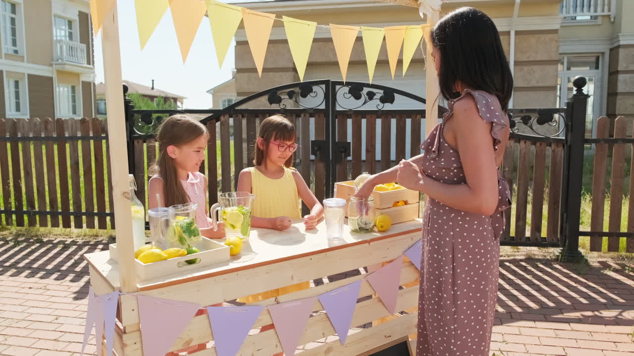 Woman Buying Lemonade From Little Girls Stand