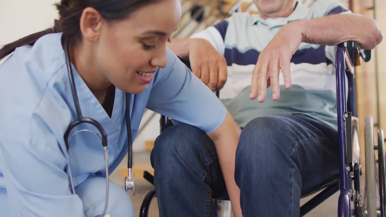 Animation of happy biracial female doctor taking care of caucasian senior man