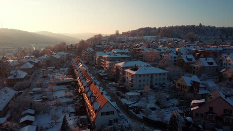 snowy day, sunrise over the roofs of winterthur