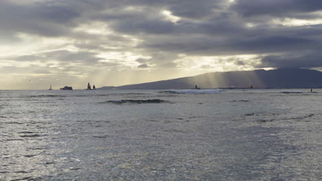 Sailing-Off-boats-and-big-ship-into-the-glowing-sunshine-on-Waikiki-Bay,-Hawaii