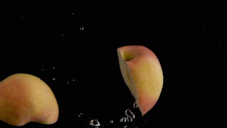 apple falling into water super slowmotion, black background, lots of air bubbles, 4k240fps