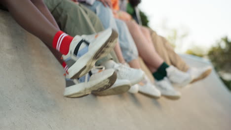 zapatos, piernas y amigos en el techo de la ciudad sentado