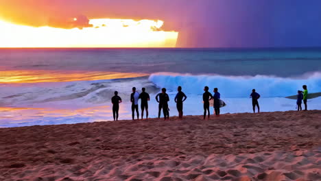surfers silhouetted against a vibrant sunset on the beach
