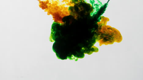 yellow-and-green-ink-merging-and-fusing,-cinematic-abstract-background-in-slowmotion